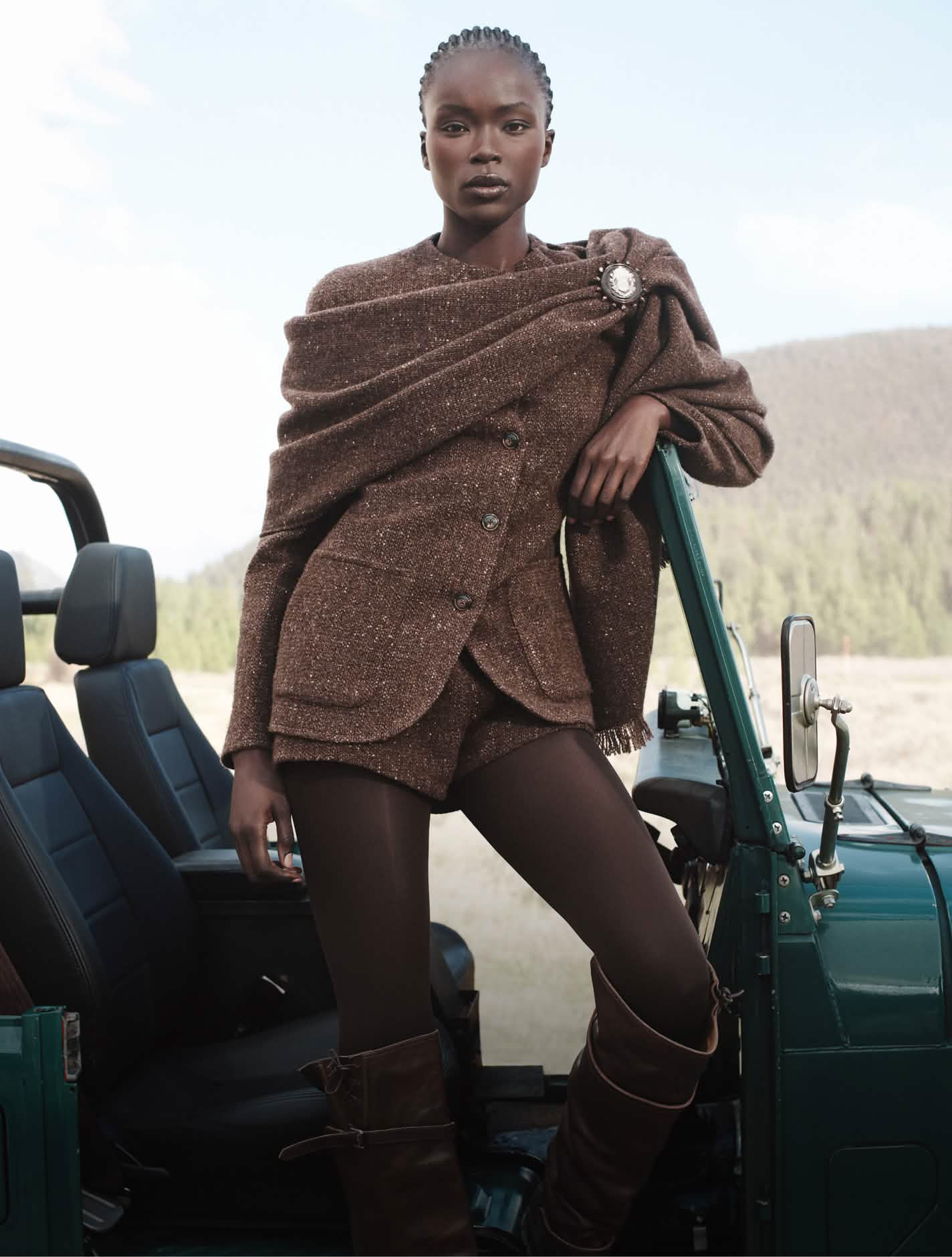 Women in brown tweed jacket, trousers and shawl 