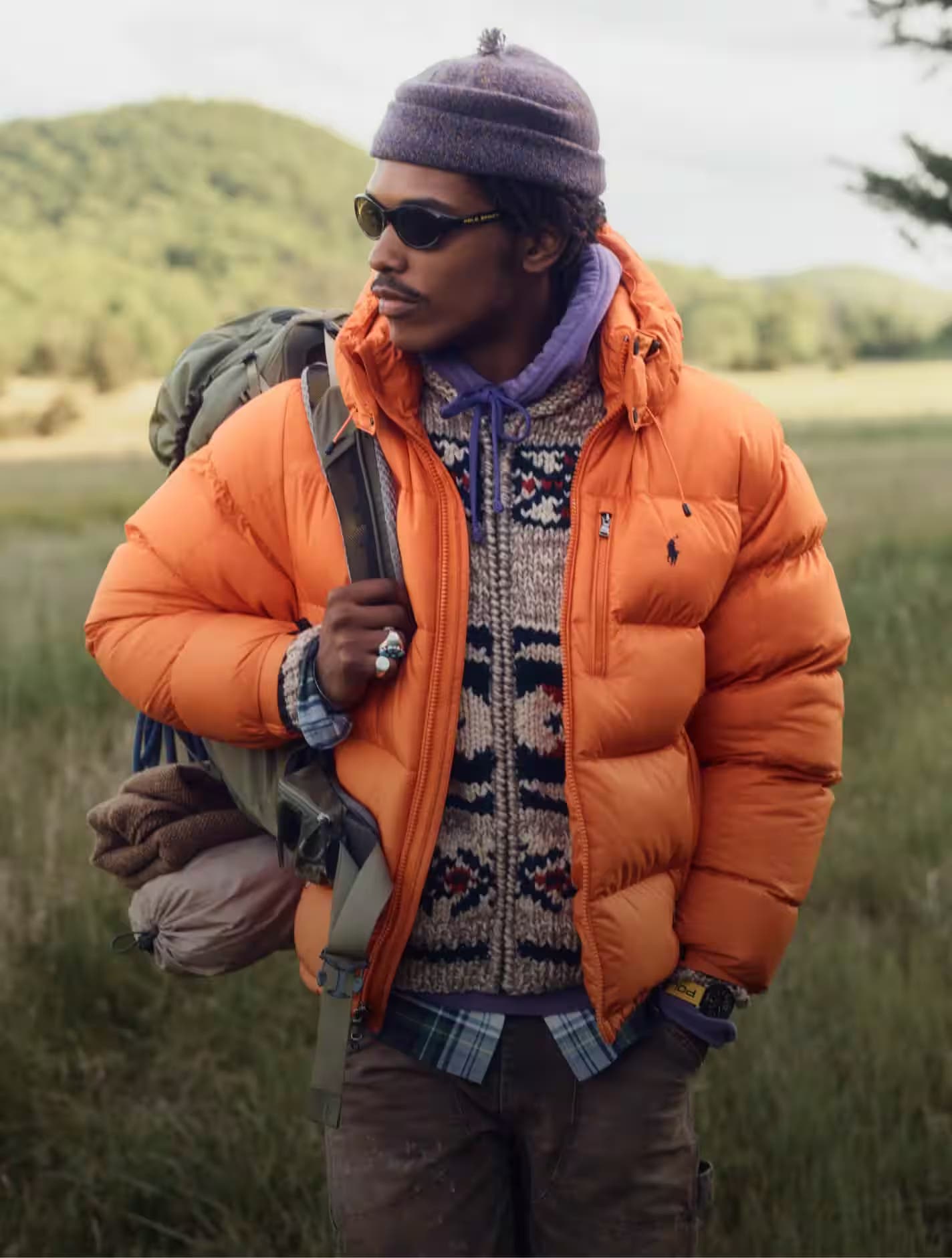 Man in orange puffa coat with Ralph Lauren logo 