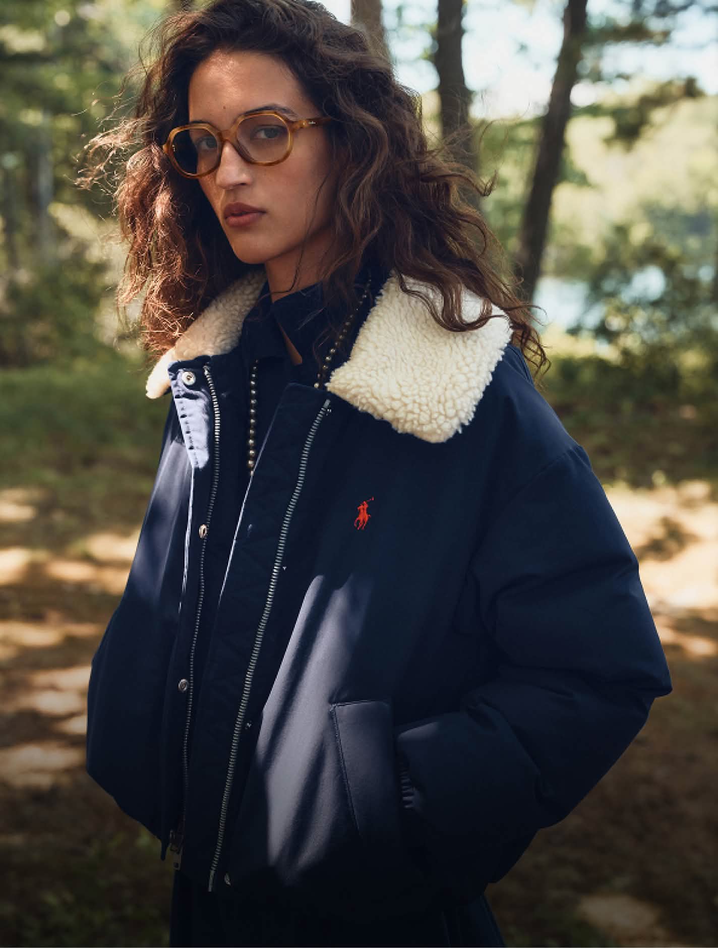 Women in navy puffa jacket with fleece collar 